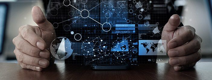 A person's hands frame a futuristic holographic display showing global data and network connections.