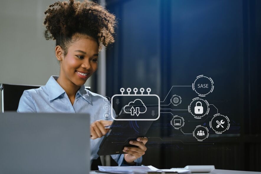 A woman smiles while interacting with a tablet displaying a cloud computing interface and network security icons.