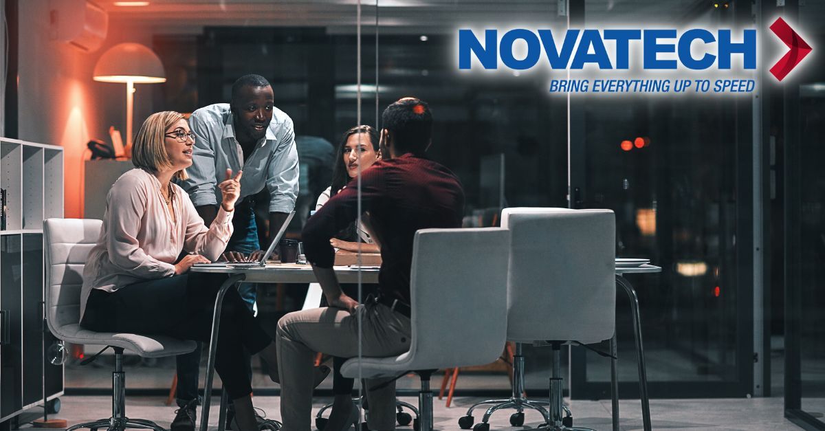 A diverse group of professionals collaborates around a table in a modern office setting, with the 