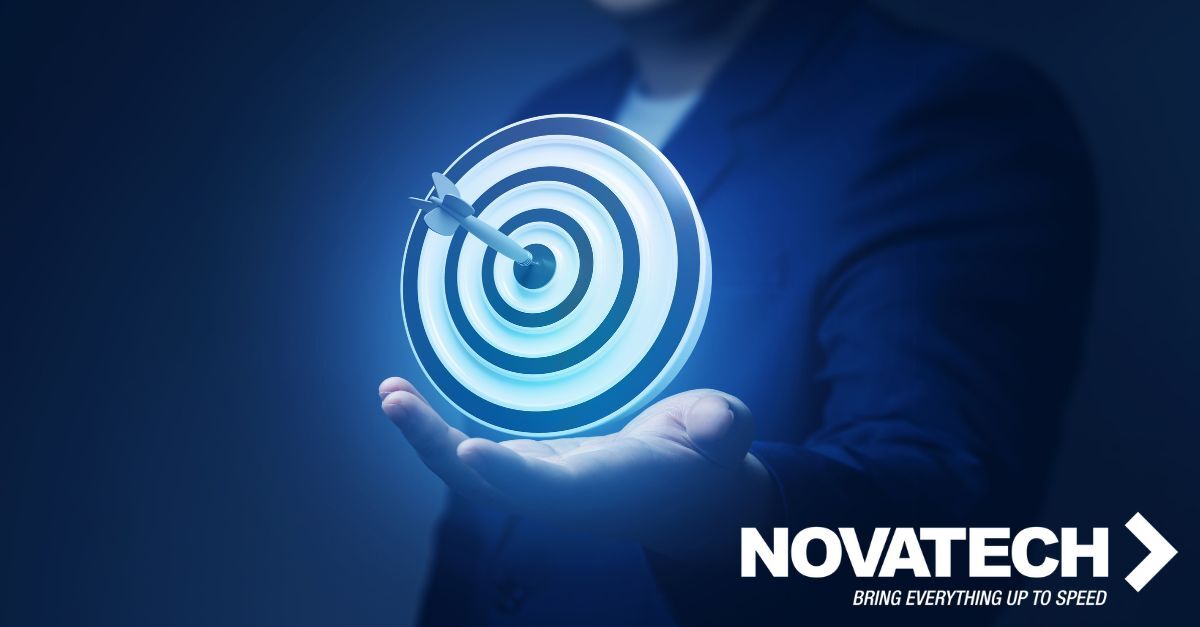 A person in a suit holds a glowing target with an arrow in the bullseye, symbolizing precision and achievement.