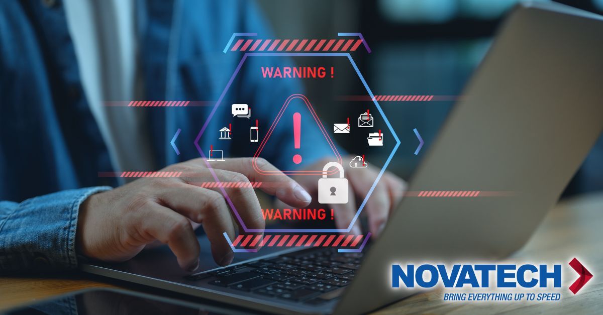 A person types on a laptop while a digital overlay displays a cybersecurity warning with icons representing data,