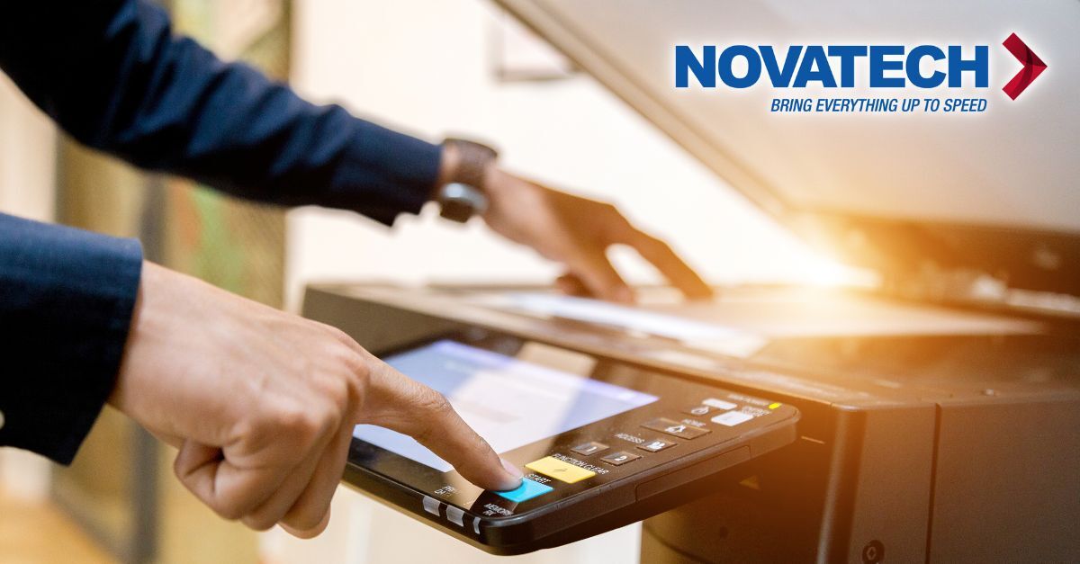 A person's hands are shown operating a copier, with the Novatech logo visible in the upper right corner.