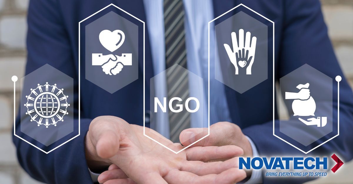 A man in a suit holds out his hands, with icons representing global community, partnership, charity, and donations