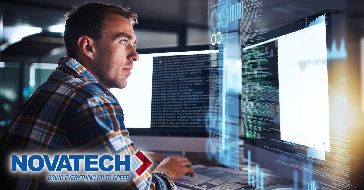 A focused tech professional is immersed in complex digital work across multiple computer screens, highlighted by the