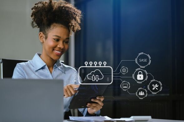 A woman smiles while interacting with a tablet displaying a cloud computing interface and network security icons.