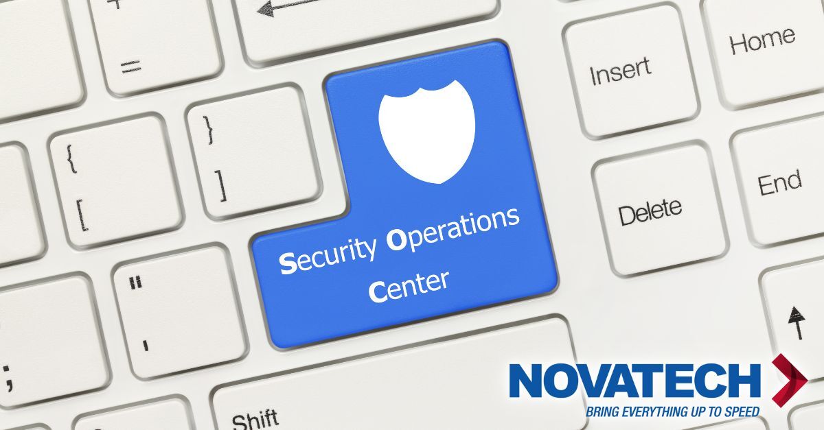 A white computer keyboard prominently displays a blue key labeled 