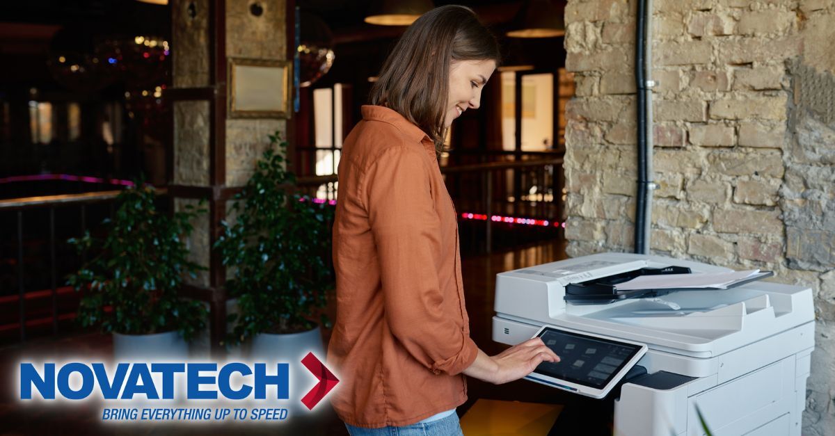 A woman interacts with a modern printer in a stylish, dimly lit office space, with the 
