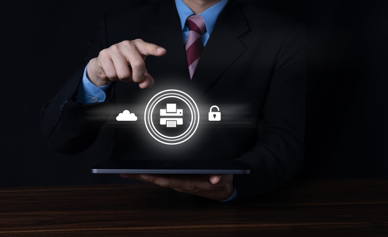 A businessman points to a digital interface displaying icons for cloud storage, printing, and security.