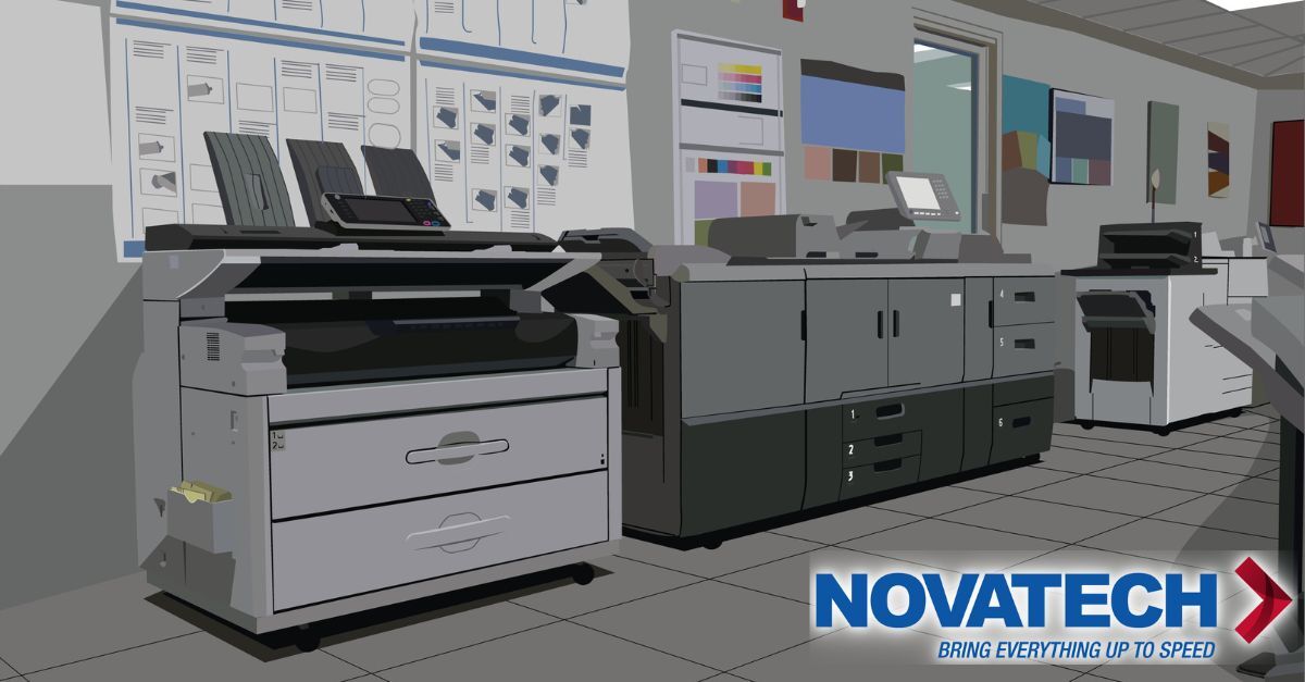 A modern office space features multiple large printing and copying machines, along with a logo for